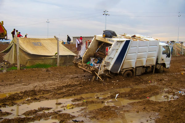 Garbage truck stuck in the mud in Domiz Refugee Camp, November 2012