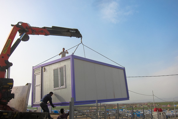 Lowering the prefabricated malnutrition building into place