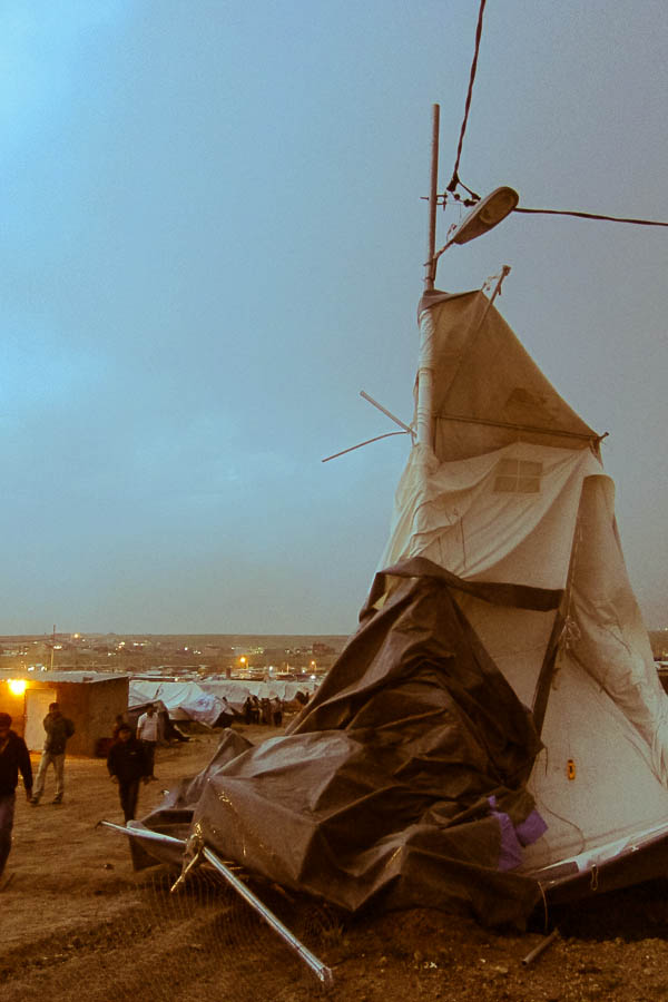 A 6x10 metre tent blown straddles a streetlamp in Domiz Refugee Camp, 16 March 2013