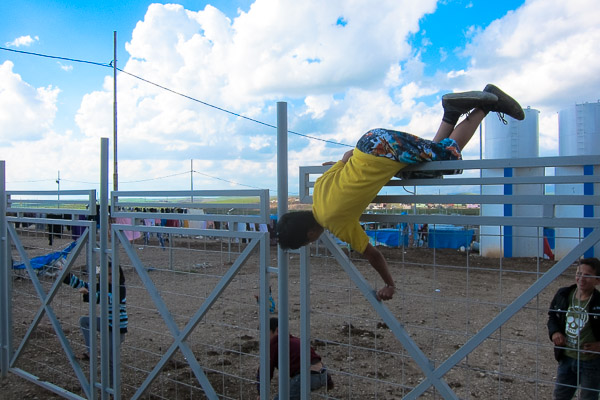 A Syrian refugee boy performs a gate vault, a move frequently used by traceurs in Parkour