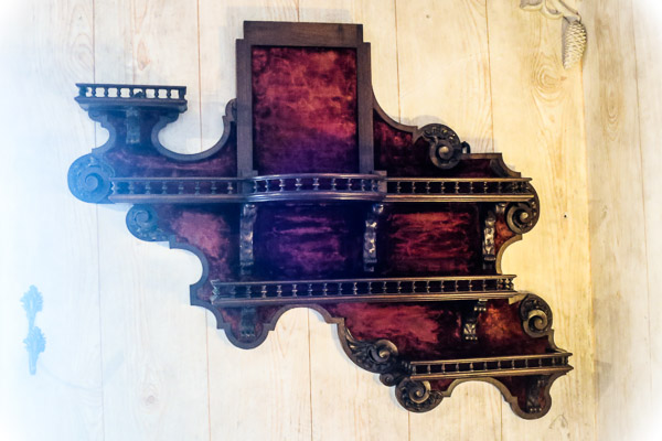 Ornate woodwork and velvet shelf at Pena Palace