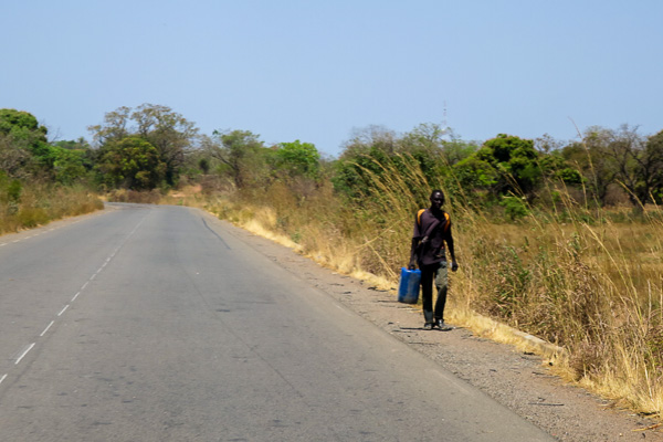 Guinean man walking along the side of the road in Haute Guinée