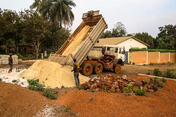 Sand delivery for construction at the Red Cross Ebola operational base in Coyah, Guinea