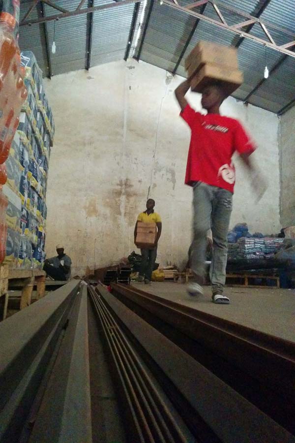 Clearing space in the big warehouse, to build a medical storeroom in Maiduguri, Borno State, Nigeria
