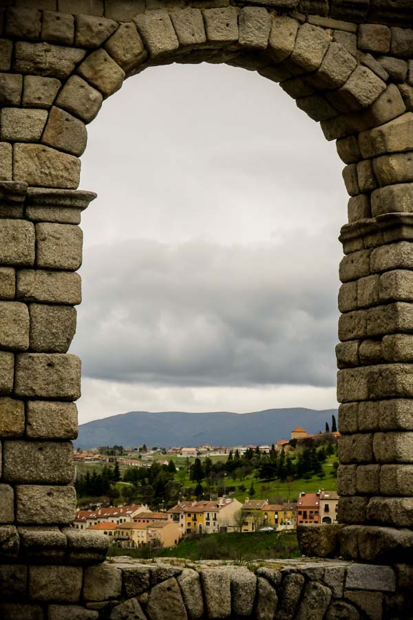 Looking through an archway in the Roman aqueduct in Segovia