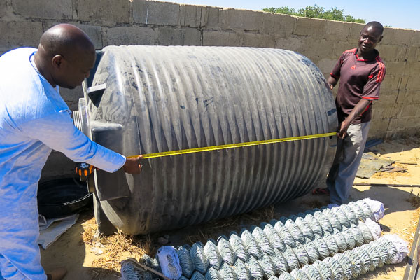 Measuring water tanks for a camp distribution system, Monguno, Borno State, Nigeria